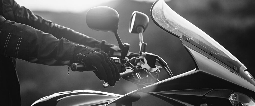 motorcycle rider holding the handlebars as they learn to ride