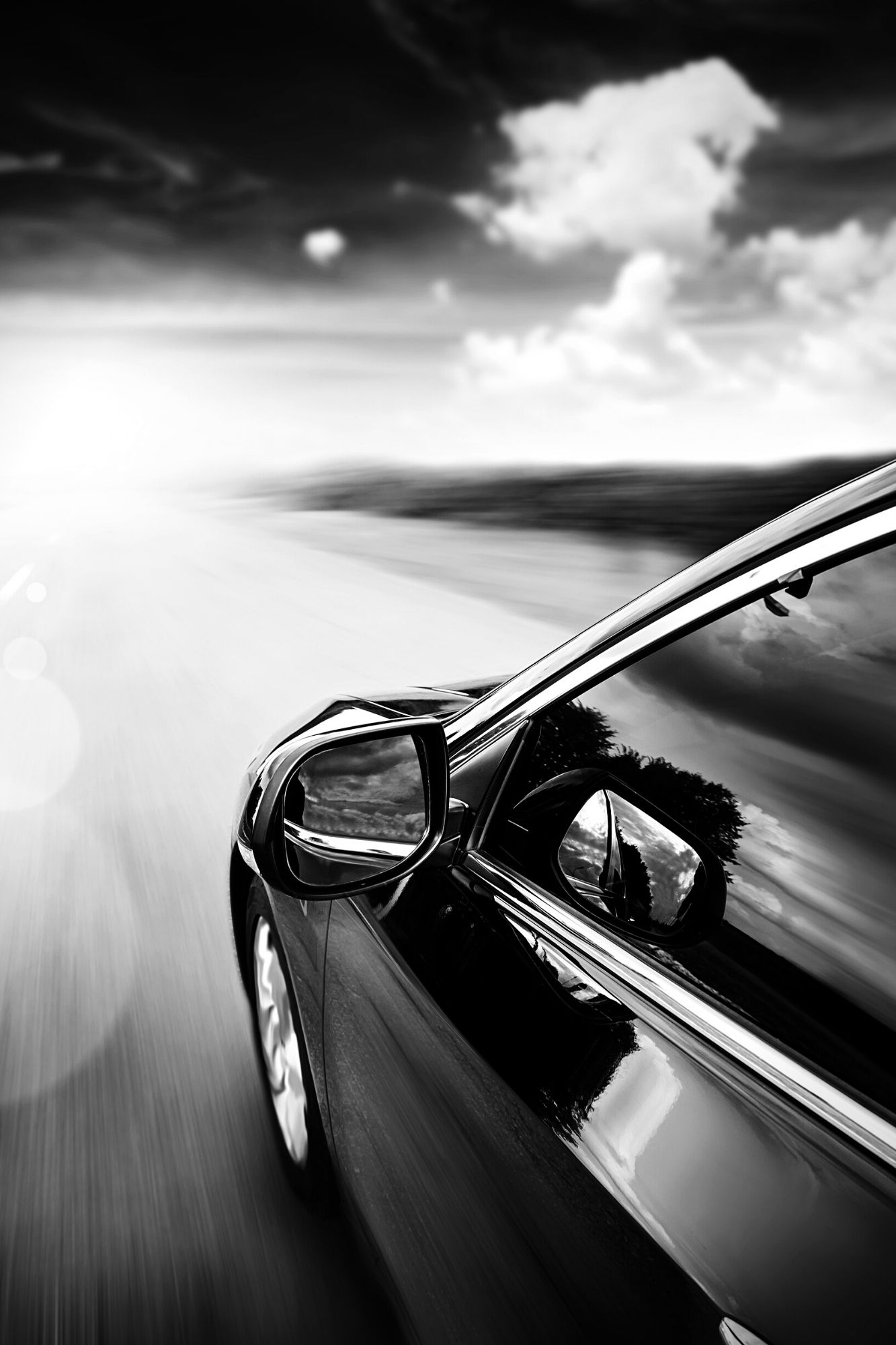 close up on drivers education car mirror driving down an empty road